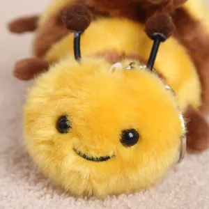 Fluffy cute bee plush keychain detail close up, soft insect toy pendant for bags or keys.