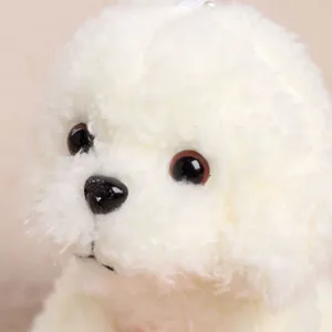 Cute white fluffy poodle plush toy pendant detail, soft stuffed animal toy close-up view.
