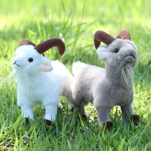 Detailed view of simulation goat plush toys with realistic horns, soft fur, outdoor grass scene.