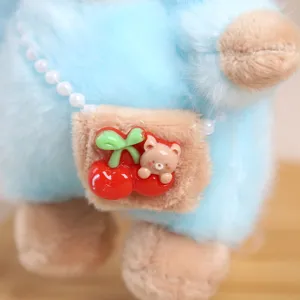 Close-up detail of cute plush sheep doll pendant with mini bag, cherry and bear charm.