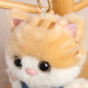 Cute plush cat keychain detail shot, fluffy stuffed animal backpack pendant toy for keys and bags.