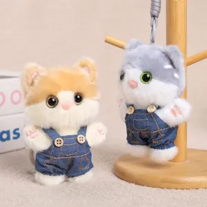 Cute cat plush keychain, fluffy kitten doll in denim overalls, adorable bag charm pendant.