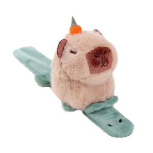 Cute capybara plush toy with orange decoration and green alligator slap bracelet for kids gifts.