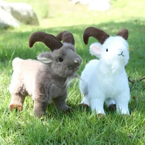 Close-up detail of realistic simulation goat plush toys on green grass, soft and detailed.