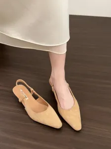 Detailed view of women's pointed-toe slingback low heel shoes in elegant beige suede.