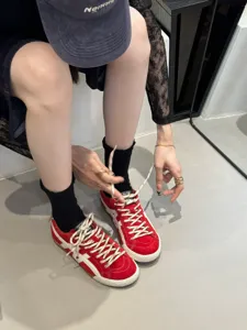 Red retro low-top women training shoes detail view, classic casual flat sneakers.