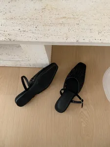Detailed view of the black French retro square toe cut-out flat shoes, elegant cutout upper design.