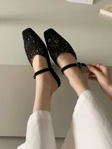 Black hollow square toe Mary Jane shoes detail view, retro design with elegant cutout mesh.