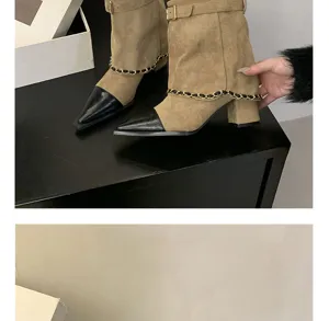 Detailed view of pointed toe suede block heel short boots with metallic chain decor design.