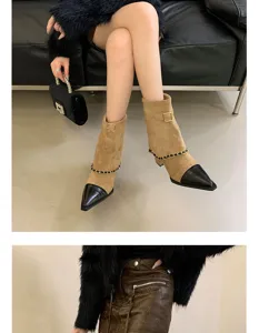Detail view of women's pointed-toe suede boots featuring elegant black cap-toe and chic chain strap.