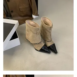 Stylish suede block heel ankle boots with chic chain detail and classic two-tone pointed toe.