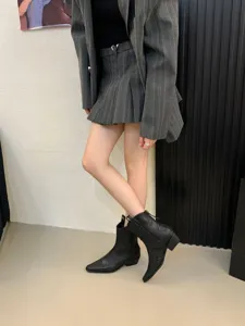 Women pointed toe western cowboy short boots chunky heel retro stylish footwear detail view.