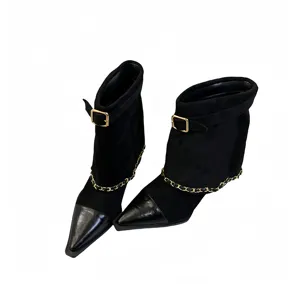 Women black suede pointed toe ankle boots with gold chain and buckle, stylish chunky heels.