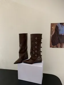 Brown pointed toe knee high boots with multiple buckle straps for women autumn winter fashion.