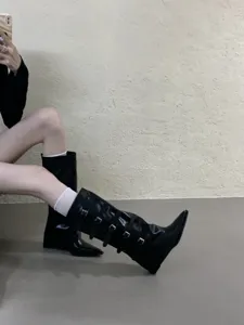 Black pointed toe knee high boots with wedge heels and multiple buckle straps for women autumn.