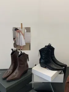 Detailed shot of retro western ankle boots with chunky heels, showing classic vintage style.