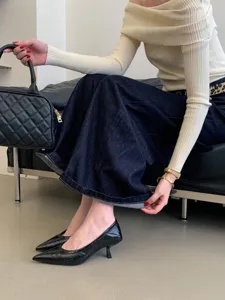 Stylish women pointed-toe kitten heel dress shoes, elegant office footwear detail view.