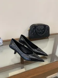 Black pointed-toe kitten heel pumps for women, elegant commuting stylish footwear detailed view.