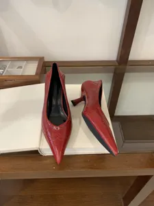 Red pointed toe kitten heels for women, elegant glossy leather dress shoes with chic brogue cutout details.
