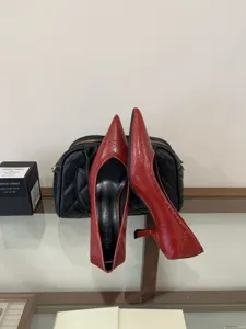 Red pointed kitten heel dress shoes detail view, elegant leather work pumps for women.