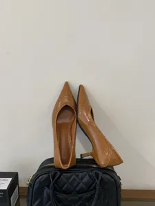 Brown pointed-toe kitten heel pumps with elegant brogue details for women stylish autumn work.