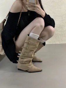 Detail shot of women's retro suede multi-buckle knee high boots with pointed toe design.