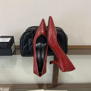 Stylish red pointed-toe kitten heels for women, elegant commuter footwear with low stiletto heel.