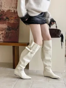White slouched knee high boots with square toe and double buckle details for women.