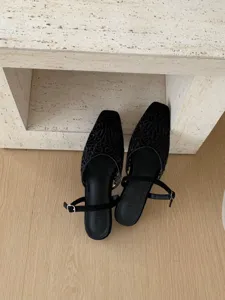 Black vintage embroidered square toe low heel shoes detail view, elegant footwear design.