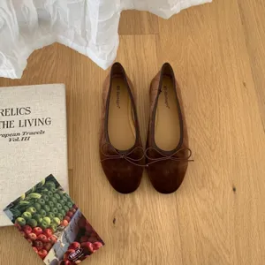 Detail view of brown velvet ballet flats with bow, comfortable flat shoes for women.