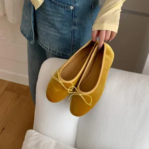 Yellow velvet ballet flats with delicate bow detail, comfortable flat slip-on shoes.