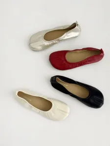 Close-up view of stylish split-toe flat shoes in multiple colors, soft leather detail.