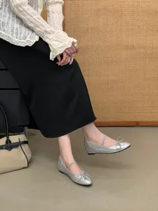 Elegant silver sequin Mary Jane flat shoes with cute bow detail, styled in chic outfit.