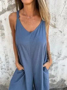 Casual solid color cotton linen spaghetti strap jumpsuit featuring convenient side pockets.
