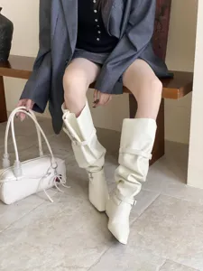 Chic white knee-high boots with stylish multi-buckle strap details and comfortable low heels.