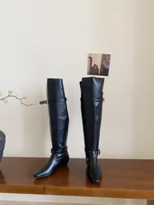 Stylish black over-the-knee long boots featuring square toe and metal buckle details.