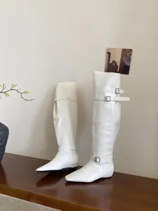 White square-toe leather long boots featuring stylish double buckle straps and low flat heels.