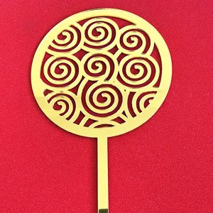 Gold acrylic Chinese style cake topper featuring elegant hollow swirl pattern detail.