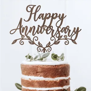 Wooden cake topper detail shot, featuring "Happy Anniversary" lettering on a decorated party cake.