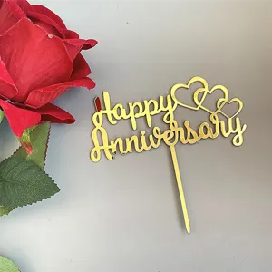 Gold acrylic Happy Anniversary cake topper detail with heart design for party decoration.