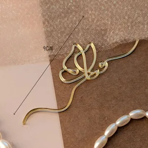 Gold acrylic abstract butterfly cake topper detail view, elegant party decoration accessory.