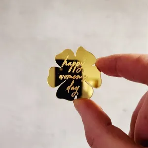 Gold mirror acrylic flower cake topper engraved with happy womens day, ideal for party decoration.