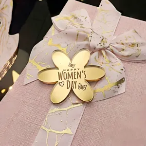 Gold mirror acrylic flower cake topper with Women's Day design for party baking decor.