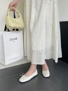 Close-up detail of retro flat ballet shoes with delicate bow knot, elegant shallow-mouth design.