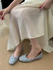 Detail shot of light blue square toe flat ballet shoes with sweet bow, comfortable soft design.