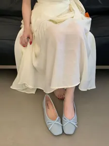 Square toe bow flat ballet shoes detail shot, soft sole comfortable casual footwear design.