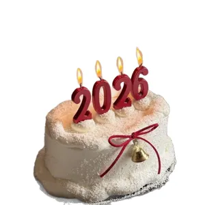 2026 New Year digital candle cake topper, red number candles with ribbon and bell decor.