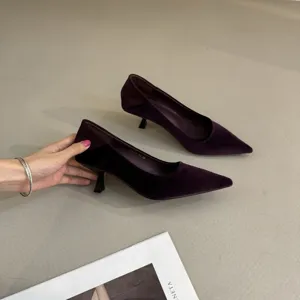Detailed view of dark purple velvet pointed-toe kitten heel pumps, elegant footwear detail.