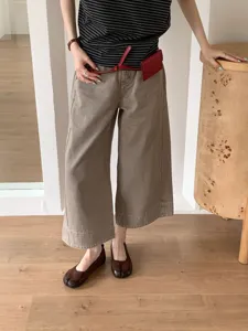Eleganti scarpe Mary Jane con punta divisa abbinate a pantaloni larghi e top a righe.