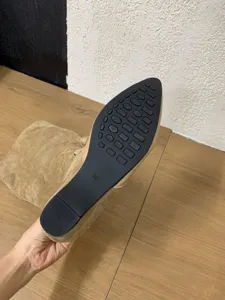 Pointed toe boot sole detail, non-slip rubber outsole texture, size 36 footwear closeup view.